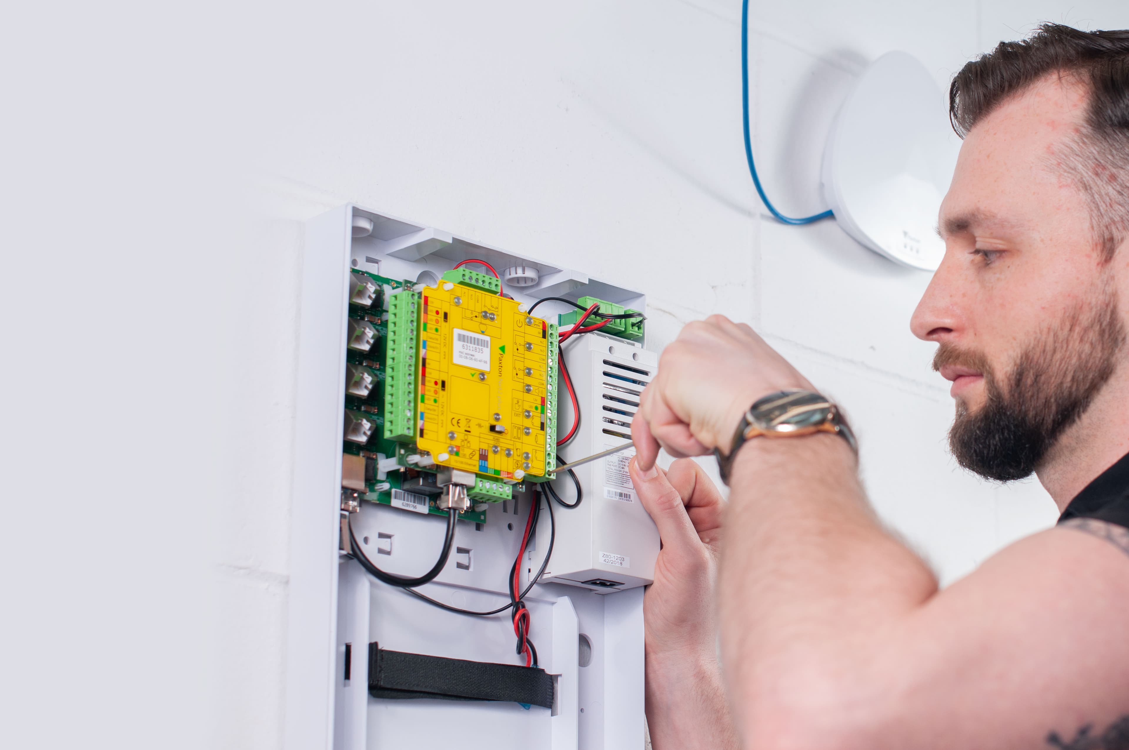 A security control unit being wired during installation